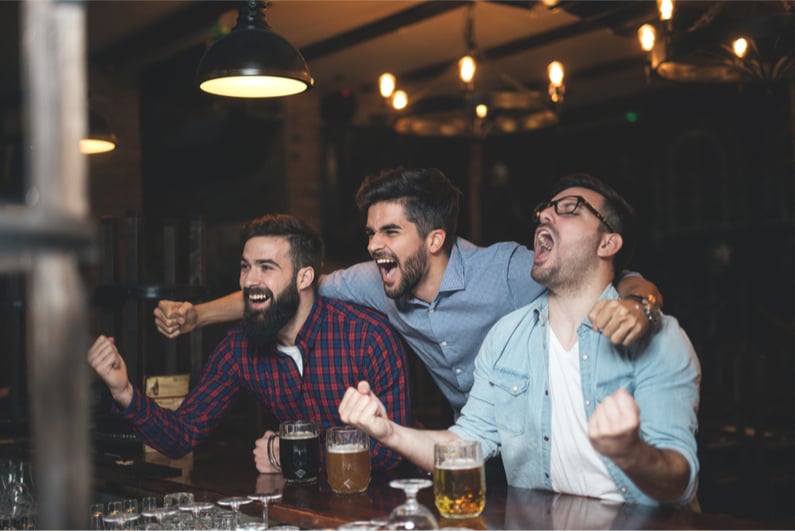 Men in pub watching a football game