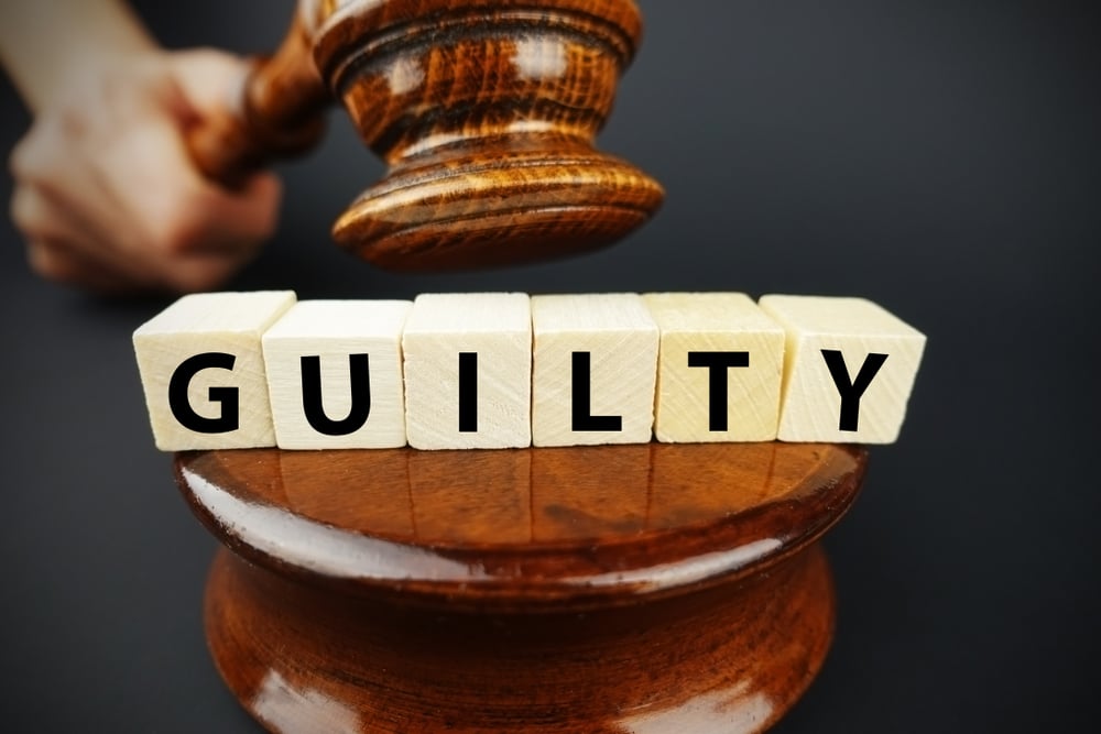 Guilty court decision with judge's gavel and wooden cubes that read GUILTY