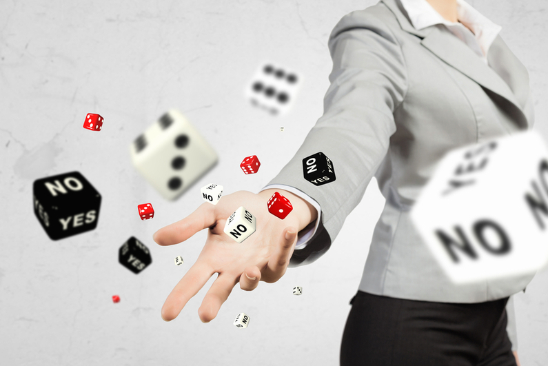 Female businesswoman throwing standard and "YES/NO" dice