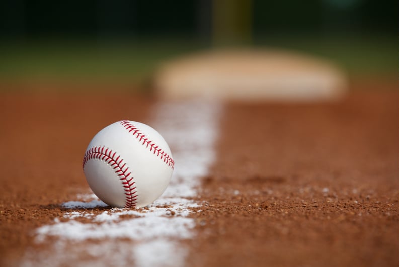 Baseball resting on the foul line